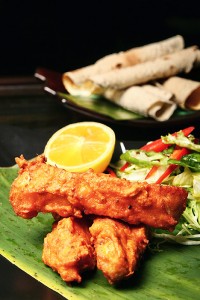An Indian restaurant dish of fried chicken and salad.