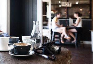 Customers in a Gold Coast cafe with coffee on a table