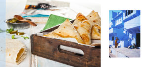 An image of samosas served in a rustic timber box with a flat-bread packet in the background. This food image is accompanied by a colourful travel street portrait of an Indian woman carrying a tray of wheat on her head which complements the food shot.